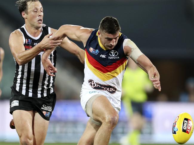 Crows midfielder Patrick Wilson comes under the close scrutiny of Port Adelaide’s Cameron Sutcliffe during Adelaide’s five-goal loss to the Magpies. Picture SARAH REED