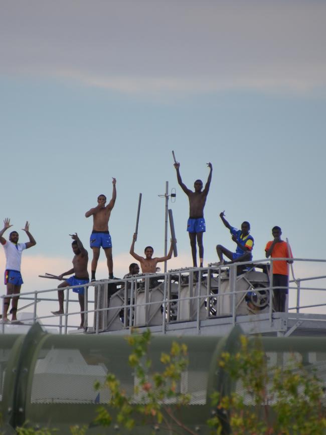 Youths rioting on top of a building at Cleveland Youth Detention Centre. Picture: DOMANII CAMERON