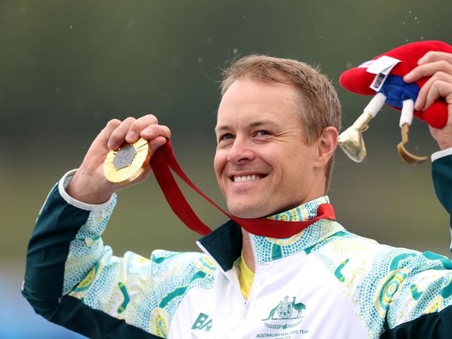 PARIS, FRANCE - SEPTEMBER 07: Gold medalist, Curtis Mcgrath of Team Australia celebrates on the podium during the Para Canoe - Men's Kayak Single 200m - KL2 medal ceremony on day ten of the Paris 2024 Summer Paralympic Games at Vaires-Sur-Marne Nautical Stadium on September 07, 2024 in Paris, France. (Photo by Steph Chambers/Getty Images)