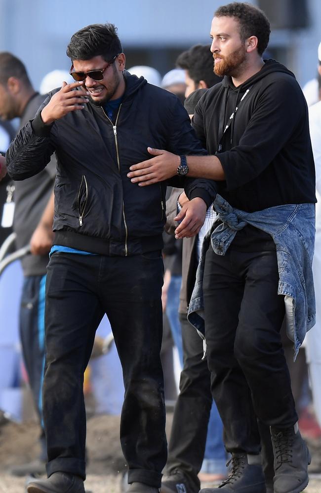 A mourner reacts during a mass burial at Memorial Park Cemetery in Christchurch, New Zealand. Picture: Getty Images