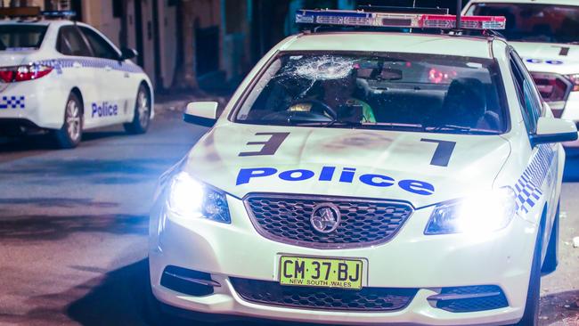 A man was arrested in an unrelated incident at the same unit block after a police car was damaged with a cricket bat. Picture: Dean Asher/TNV