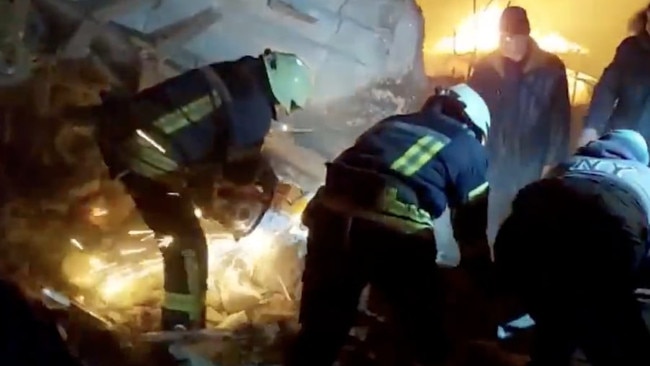 The footage shows rescue workers hauling away debris in search of survivors.