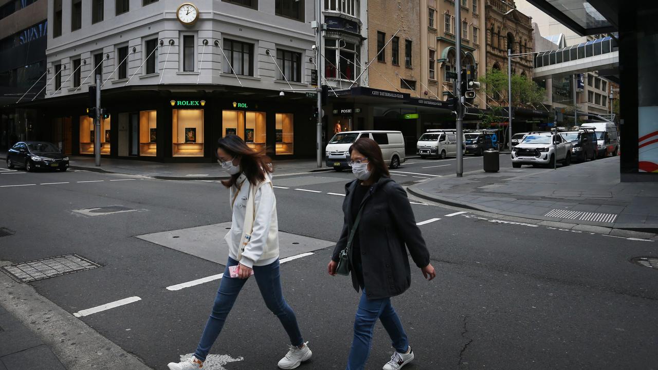 Pedestrians cross an empty Market Street in Sydney on September 16. Picture: Lisa Maree Williams/Getty Images