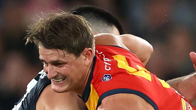 MELBOURNE, AUSTRALIA - APRIL 13: Matt Crouch of the Crows is tackled by Matthew Kennedy of the Blues during the round five AFL match between Carlton Blues and Adelaide Crows at Marvel Stadium, on April 13, 2024, in Melbourne, Australia. (Photo by Quinn Rooney/Getty Images)