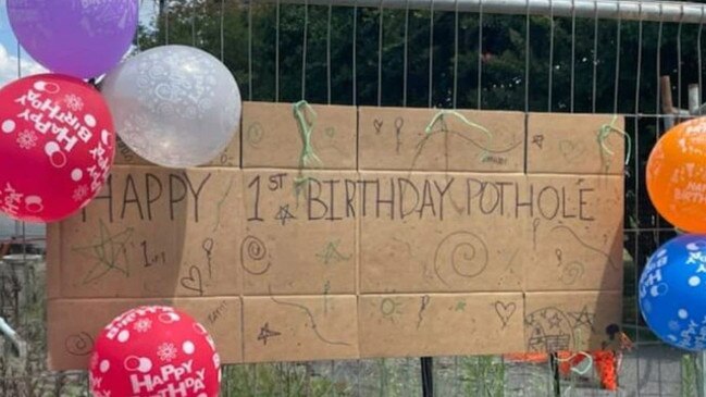 The gaping hole on Maudsley Street, Goomeri is closed off to vehicles and was decorated with decorated with birthday balloons and a large birthday card.