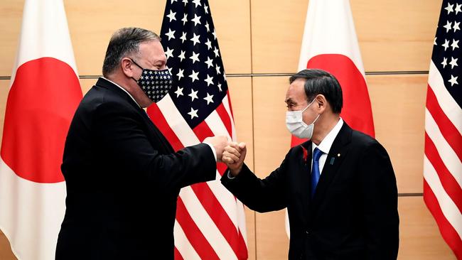 Japan Prime Minister Yoshihide Suga and US Secretary of State Mike Pompeo bump fists as they meet in Tokyo on October 6. Picture: AFP