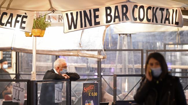 An employee waits for customers on an empty terrace at Campo de' Fiori square in Rome on Friday. Picture: AFP