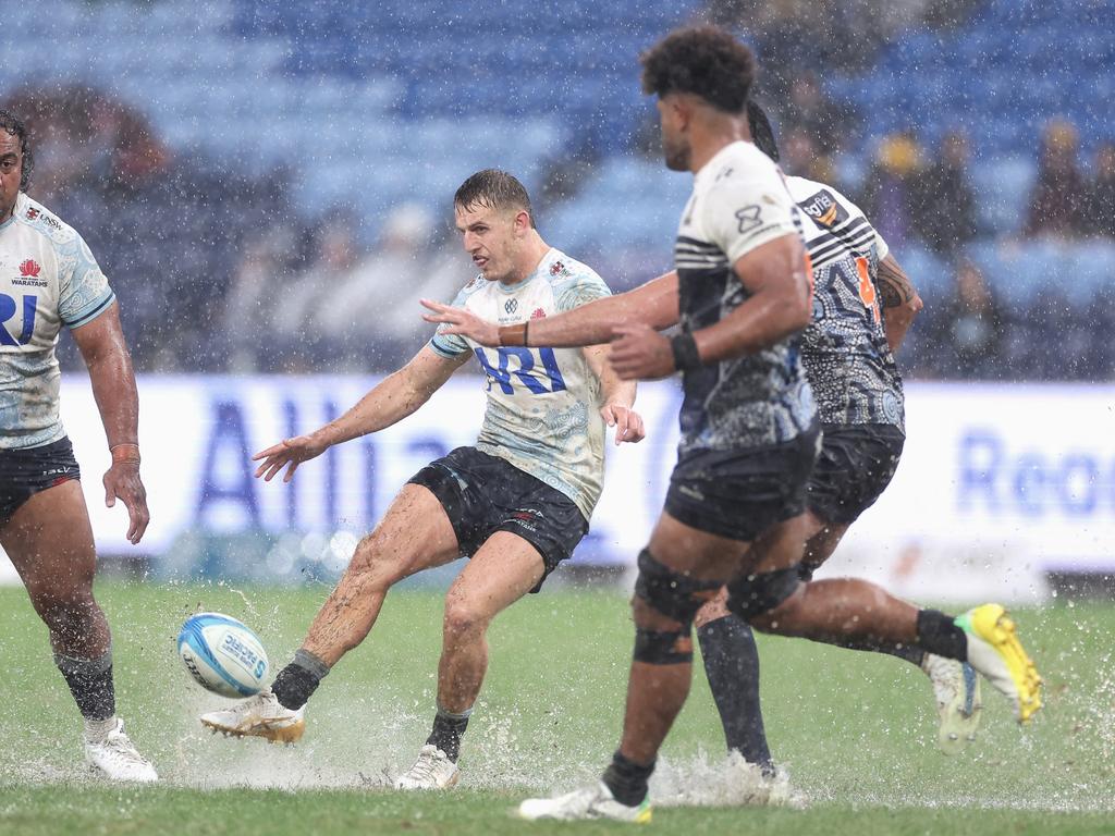 Waratahs’ Joey Walton puts in a kick in horrendous conditions at Allianz Stadium. Picture: Getty Images