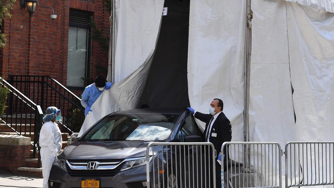 A hearse picks up deceased bodies from a refrigerated truck outside Brooklyn Hospital. Picture: Angela Weiss/AFP