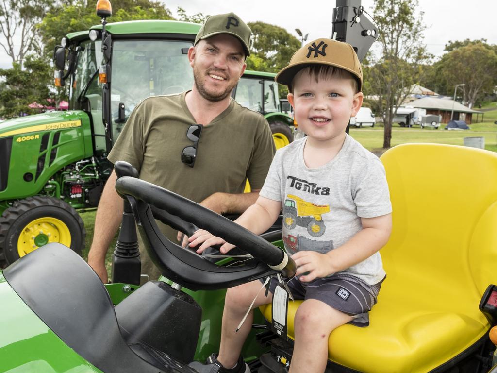 Corey Goostrey and his son Cooper Goostrey 3yo check out the tractor display at the Toowoomba Royal Show. Saturday, March 26, 2022. Picture: Nev Madsen.