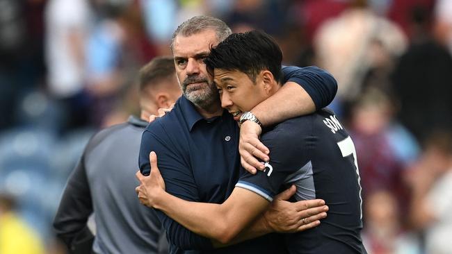 Tottenham Hotspur's Greek-Australian Head Coach Ange Postecoglou (L) embraces Tottenham Hotspur's South Korean striker #07 Son Heung-Min (R) on the pitch after the English Premier League football match between Burnley and Tottenham Hotspur at Turf Moor in Burnley, north-west England on September 2, 2023. Tottenham won the game 5-2. (Photo by Paul ELLIS / AFP) / RESTRICTED TO EDITORIAL USE. No use with unauthorized audio, video, data, fixture lists, club/league logos or 'live' services. Online in-match use limited to 120 images. An additional 40 images may be used in extra time. No video emulation. Social media in-match use limited to 120 images. An additional 40 images may be used in extra time. No use in betting publications, games or single club/league/player publications. /