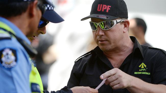 Dennis Huts, president of the Perth United Patriots Front, receives a ‘move on’ notice from police at a rally in the WA capital.