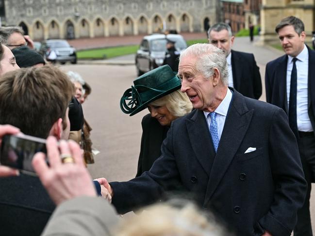 The king struck a joyous figure in the morning cold. Picture: AFP