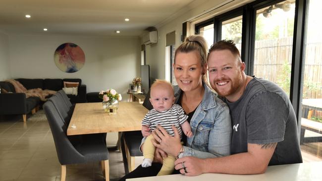 Dylan McKibbin, 29, wife Hayley, 28 and 11-week-old son Jett are focused on building up a rainy day savings account. They recently refinanced their home loan to save money too. Picture: Tony Gough