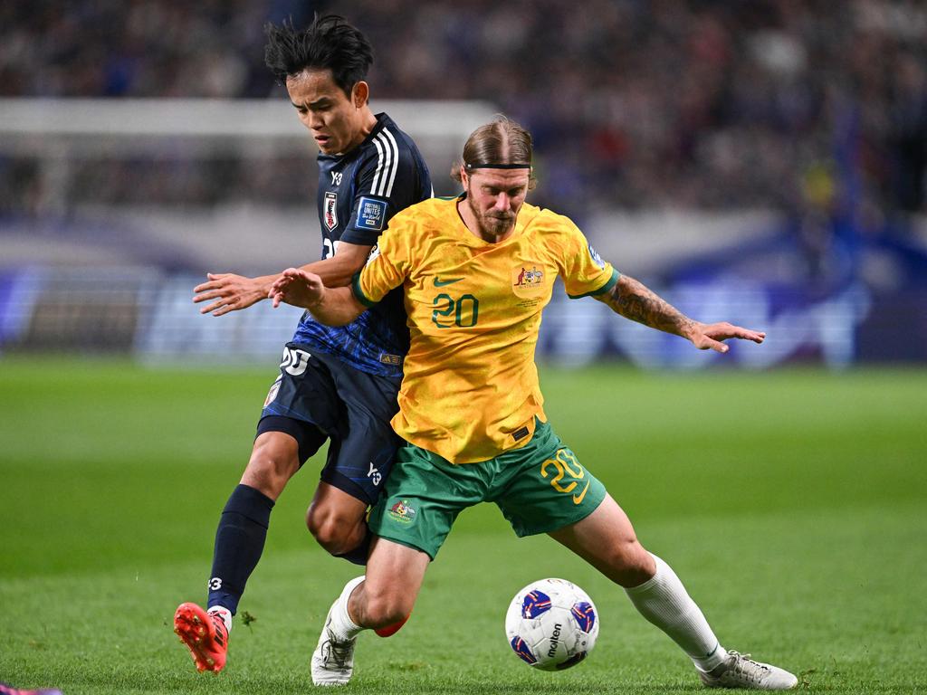 Socceroos debutant Luke Brattan (right) battles Japan's Takefusa Kubo in the 1-1 draw in Saitama. Picture: Philip Fong / AFP