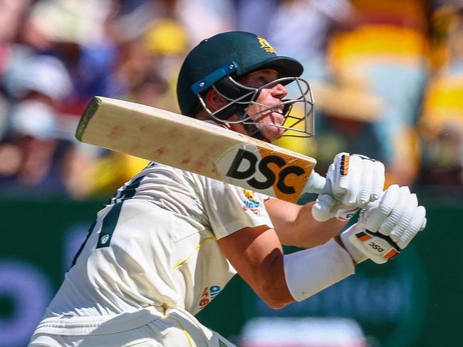 Australia's David Warner hooks England's Jack Leach for 4 runs, during day two of the first Ashes cricket Test match between England and Australia at the Gabba in Brisbane on December 9, 2021. (Photo by Patrick HAMILTON / AFP) / -- IMAGE RESTRICTED TO EDITORIAL USE - STRICTLY NO COMMERCIAL USE --