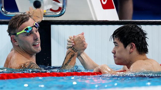 NANTERRE, FRANCE - JULY 31: Zhanle Pan of Team People's Republic of China celebrates with Kyle Chalmers of Team Australia after winning gold and silver in the Men's 100m Freestyle Final on day five of the Olympic Games Paris 2024 at Paris La Defense Arena on July 31, 2024 in Nanterre, France. (Photo by Quinn Rooney/Getty Images)