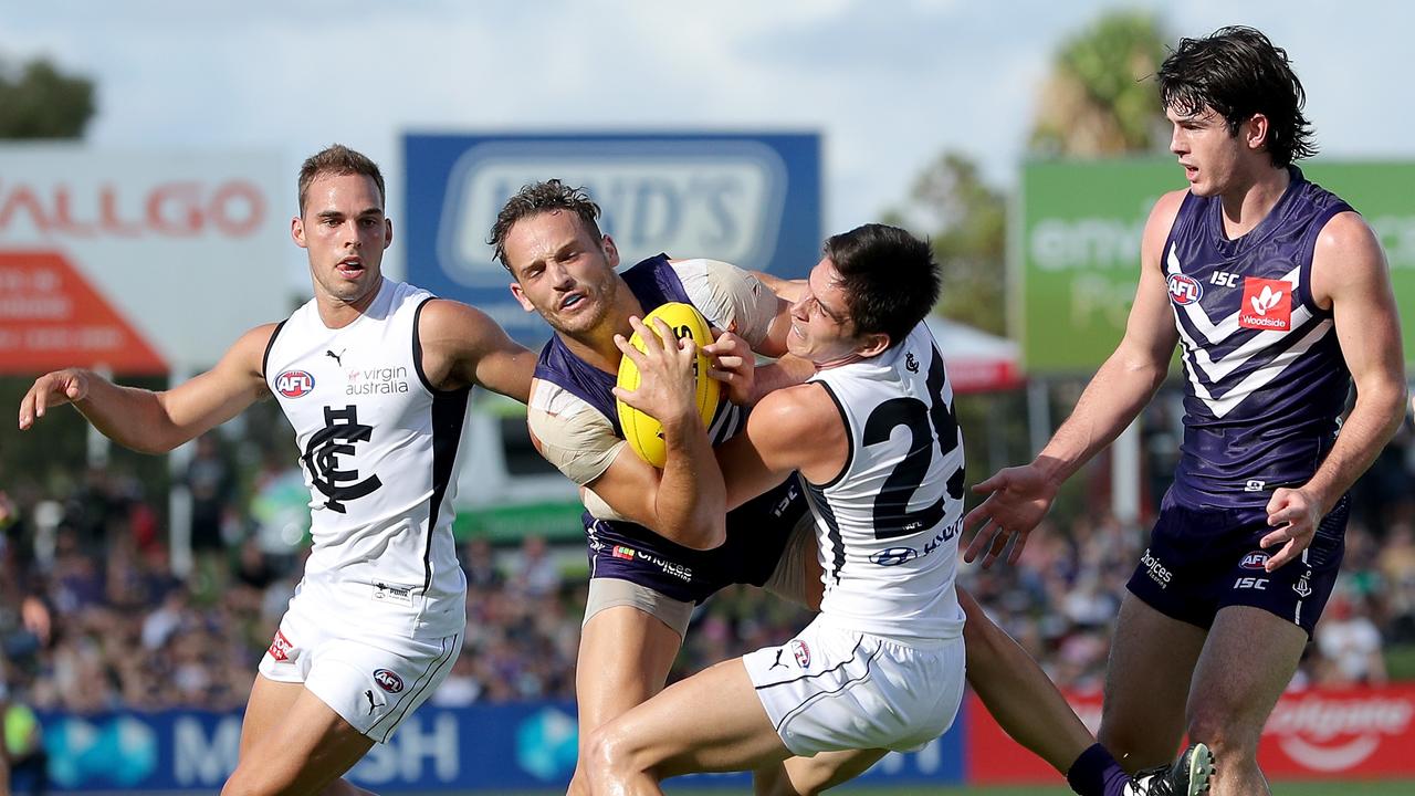 Zac Fisher of the Blues tackles James Aish of the Dockers
