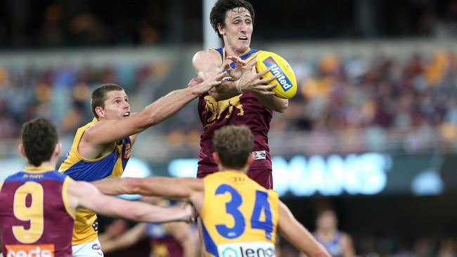 Lions ruckman Oscar McInerney soars high against the Eagles. Picture: Jono Searle/AFL Photos/via Getty Images