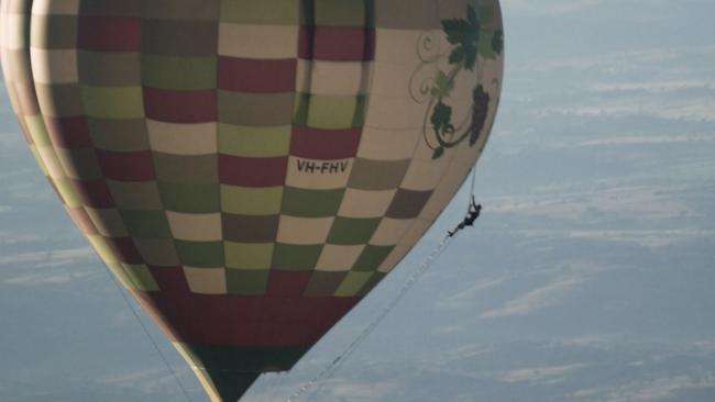 Gold Coast-based extreme athlete Damien Rider climbed up the side of a hot-air balloon at 10,000 feet on a rope ladder above Bathurst and then parachuted off the top. Picture: Supplied.