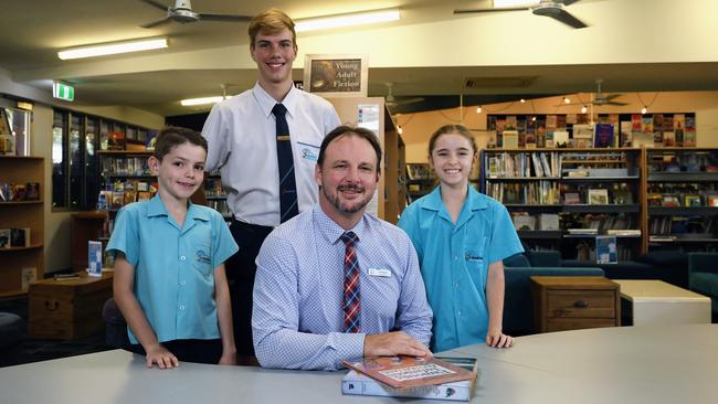 St Andrew's Catholic College at Redlynch is one of the best funded schools in Far North Queensland. St Andrew's Catholic College principal Ian Margetts with students Archer Wickerson, Edward Hamilton and Lilly Hogan in the school library. Picture: Brendan Radke