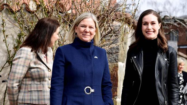 Sanna Marin, right, with Swedish Prime Minister Magdalena Andersson, centre, whose country is also considering whether to join NATO. Picture: AFP