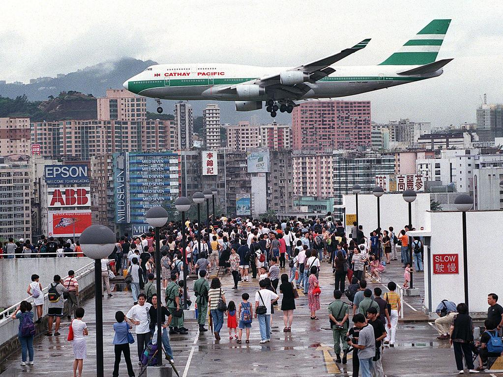 Remembered by passengers and pilots for the spectacular approach skimming rooftops to land, Kai Tak Airport closed on July 5, 1998 after 73 years in operation. Picture: Frederic Brown / AFP