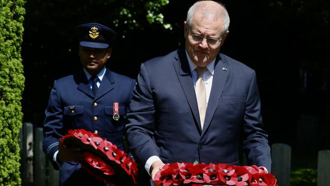 Australian Prime Minister Scott Morrison lays a wreath at the Cross of Sacrifice in remembrance of eight Royal Australian Air Force servicemen who died during World War II and are buried in St Illogan Churchyard in Cornwall. Picture: Adam Taylor/PMO