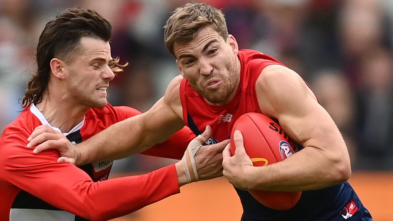 Jack Viney fends off a tackle by Jack Sinclair. Picture: Quinn Rooney/Getty Images