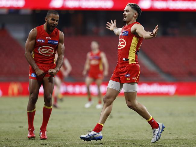 Izak Rankine of the Suns kicks celebrates after kicking his first AFL goal during the round 6 AFL match between the Melbourne Demons and the Gold Coast Suns at GIANTS Stadium on July 11, 2020 in Sydney, Australia. (Photo by Ryan Pierse/AFL Photos/via Getty Images)