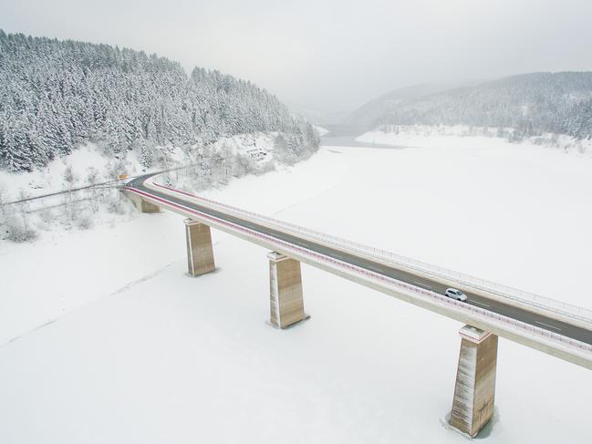 Aerial view taken on January 17, 2017 with a drone shows a car driving over a bridge crossing the Okerstausee reservoir near Schulenburg im Oberharz in the Harz region, central Germany. Picture: AFP