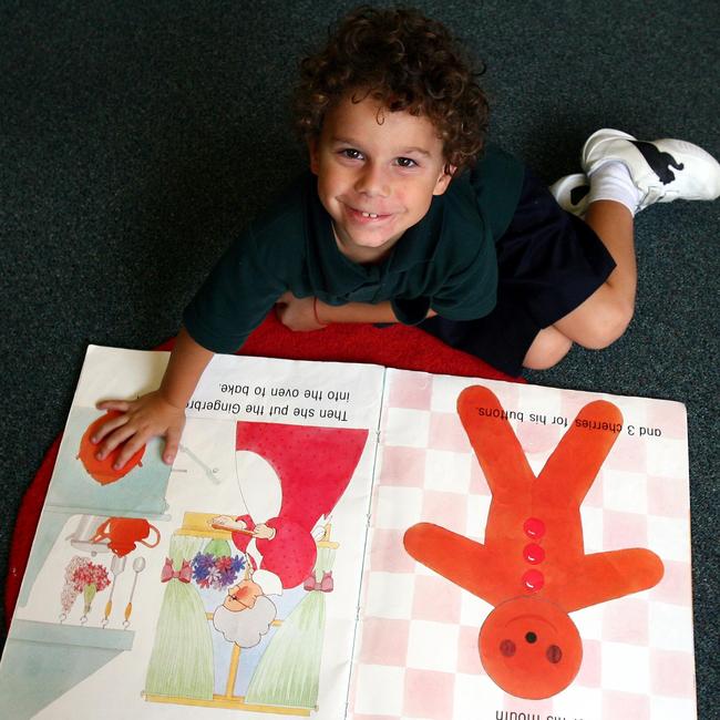 Somerset prep student Liron Lelah 5 years takes in an oversize book.