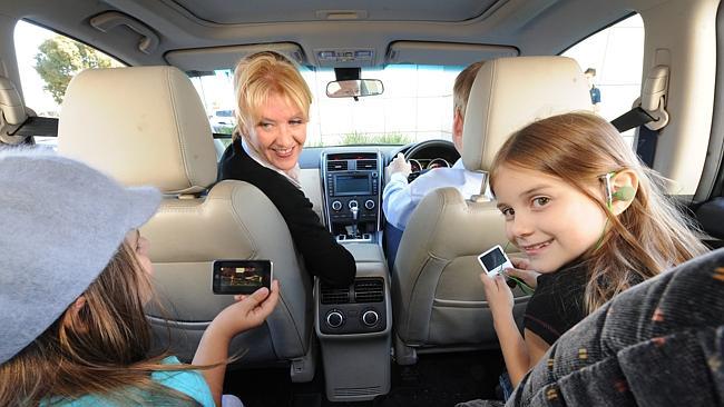  RAA road safety - generic shot of family keeping busy in the car and not distracting the driver while on driving holiday (no...