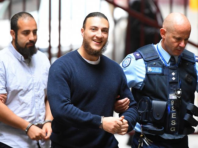 Ahmed Mohamed (centre) arrives to the Supreme Court of Victoria, Melbourne, Friday, November 29, 2019. Sentence for Christmas Day terror attack plotters Abdullah Chaarani, Ahmed Mohamed and Hamza Abbas. The trio planned to detonate bombs and machetes to attack people at Federation Square in Melbourne. (AAP Image/James Ross) NO ARCHIVING