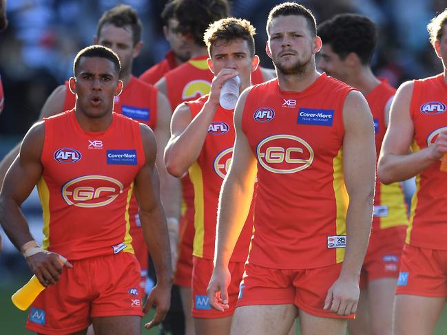 Steven May of the Suns (third from left) reacts after the Round 23 AFL match between the Geelong Cats and the Gold Coast Suns at GMHBA Stadium in Geelong, Saturday, August 25, 2018. Picture: AAP Image/Julian Smith.