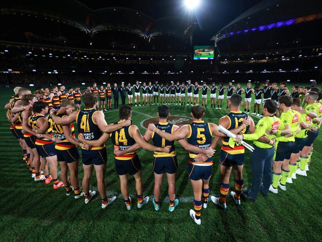 ADELAIDE, AUSTRALIA - MAY 02: A moment of silence for gender based violence during the 2024 AFL Round 08 match between the Adelaide Crows and the Port Adelaide Power at Adelaide Oval on May 02, 2024 in Adelaide, Australia. (Photo by James Elsby/AFL Photos via Getty Images)