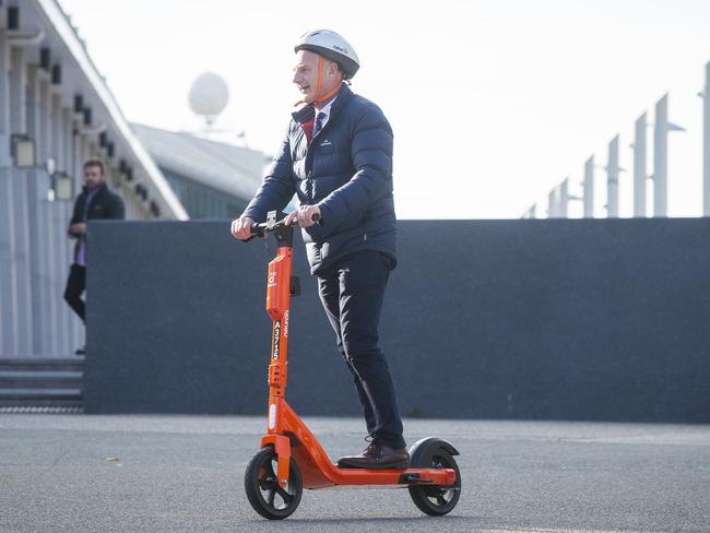 Premier Peter Gutwein rides an electric scooter to a press conference regarding a trial of e-scooters earlier this year. Picture: NCA NewsWire / Richard Jupe