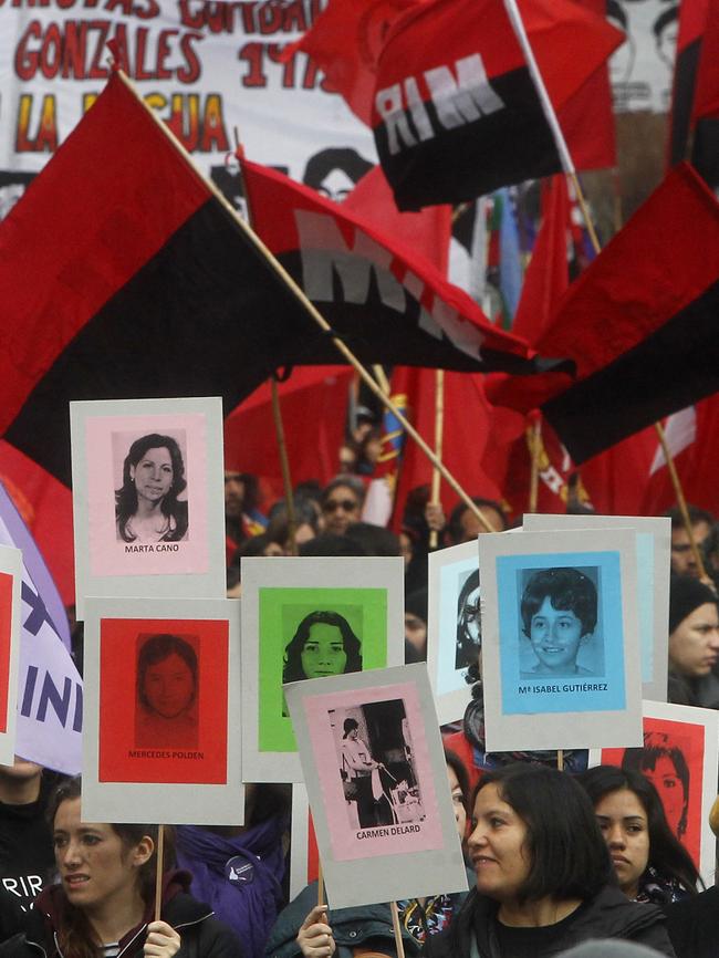 Faces of the missing ... Human Rights activists march in Santiago on the 44th anniversary of the coup. Picture: AFP