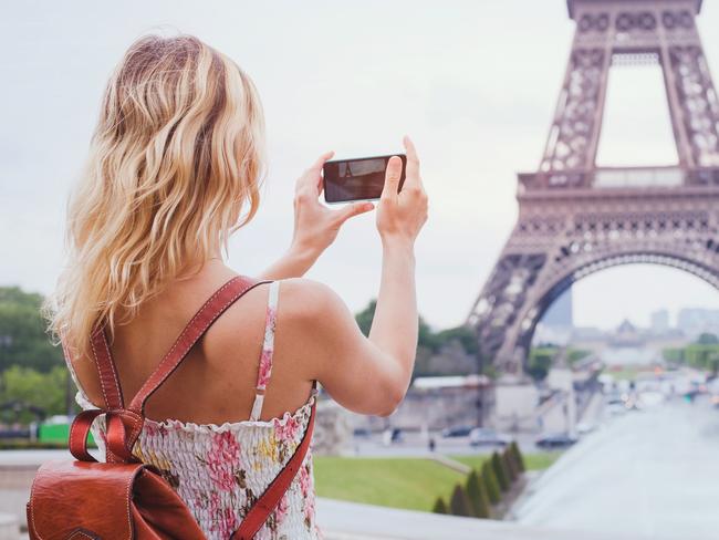 tourist taking photo of Eiffel tower in Paris with compact camera or smartphone, travel in Europe  Picture: istock