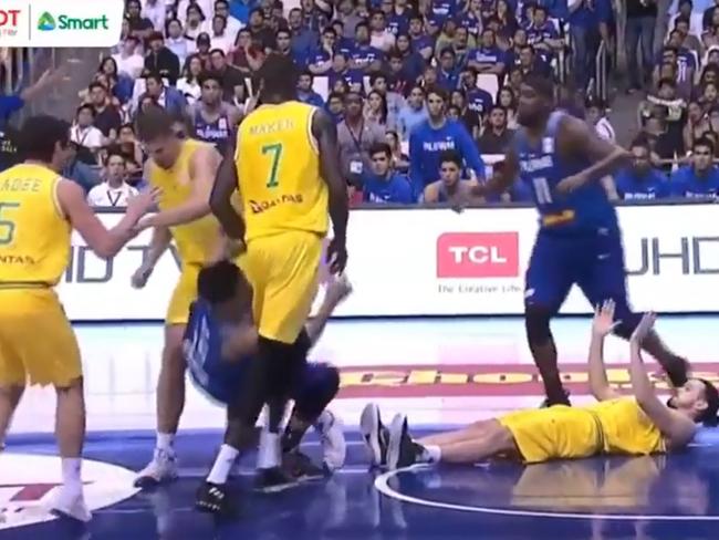 Sydney Kings player Daniel Kickert rushes from the right side of the court and lands a heavy left elbow on the jaw of Pogoy as his attention was focused on Goulding. The Phillippines team bench rise to their feet in response.