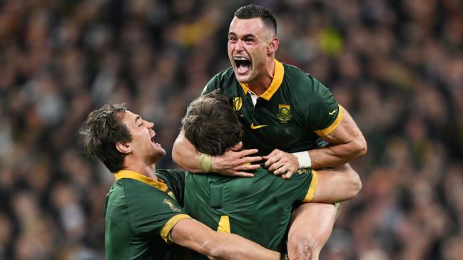 PARIS, FRANCE - OCTOBER 28: Jesse Kriel of South Africa celebrates with teammates Franco Mostert and Eben Etzebeth following the team's victory during the Rugby World Cup Final match between New Zealand and South Africa at Stade de France on October 28, 2023 in Paris, France. (Photo by Hannah Peters/Getty Images)