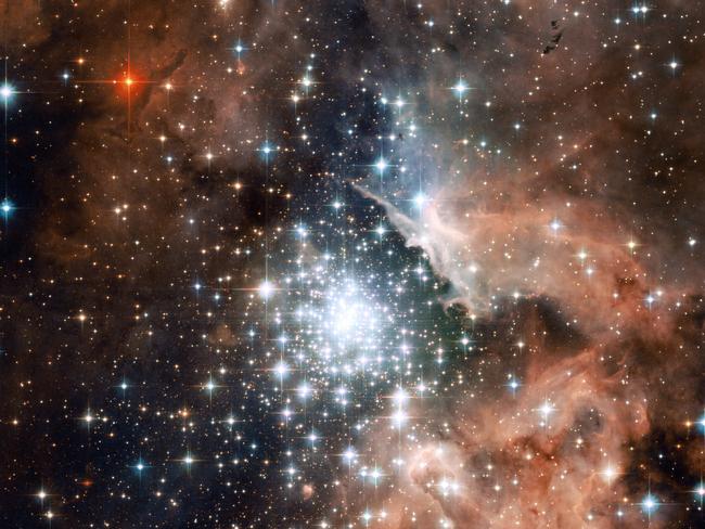 The star-forming region NGC 3603 - seen here in the latest Hubble Space Telescope image - contains one of the most impressive massive young star clusters in the Milky Way. Bathed in gas and dust the cluster formed in a huge rush of star formation thought to have occurred around a million years ago. The hot blue stars at the core are responsible for carving out a huge cavity in the gas seen to the right of the star cluster in NGC 3603's centre.