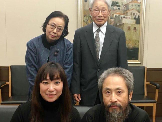 In this handout photograph made availabe by Myu Yasuda via Jiji Press on October 25, 2018, Japanese freelance journalist Jumpei Yasuda (front R), who was kidnapped in Syria three years ago, poses with his wife Myu (front L) and his parents, Sachiko (back L) and Hideaki (back R) upon his arrival at Narita Airport, in Chiba Prefecture. - A Japanese journalist who was held in Syria for more than three years before being freed this week has described his lengthy captivity as "hell." (Photo by Handout / JIJI PRESS / AFP) / Japan OUT / --  RESTRICTED TO EDITORIAL USE - MANDATORY CREDIT "AFP PHOTO / JIJI PRESS / COURTESY OF MYU YASUDA" - NO MARKETING NO ADVERTISING CAMPAIGNS - DISTRIBUTED AS A SERVICE TO CLIENTS