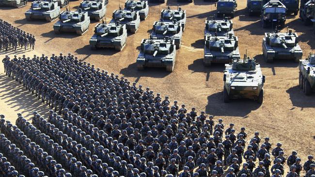 Troops file past tanks as they arrive at the parade. Picture: Zha Chunming/Xinhua via AP