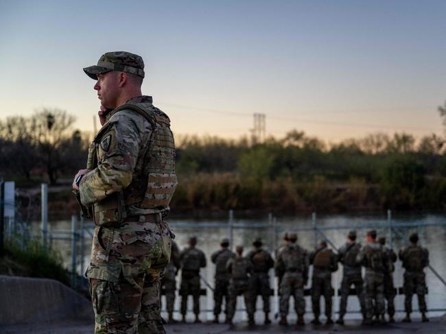 EAGLE PASS, TEXAS - JANUARY 12: National Guard soldiers stand guard on the banks of the Rio Grande river at Shelby Park on January 12, 2024 in Eagle Pass, Texas. The Texas National Guard continues its blockade and surveillance of Shelby Park in an effort to deter illegal immigration. The Department of Justice has accused the Texas National Guard of blocking Border Patrol agents from carrying out their duties along the river.   Brandon Bell/Getty Images/AFP (Photo by Brandon Bell / GETTY IMAGES NORTH AMERICA / Getty Images via AFP)