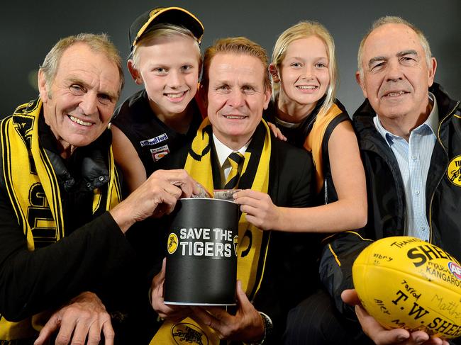 Glenelg Football Club legend Graham Cornes, fan Joe Chigwidden (11), club president Nick Chigwidden, fan Summer Ryan (12), & Club legend Peter Carey at the launch of the club's 'Save the Tigers' fund. Pictured at Phil Hoffman travel, Glenelg.picture: Bianca De Marchi