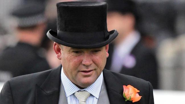 Peter Moody, Melbourne trainer of Black Caviar, walks the course during day five of the 2012 Royal Ascot meeting at Ascot Racecourse, England Saturday June 23, 2012. Black Caviar, the 5-year-old Australian mare, is ranked No. 2, behind Frankel, and will aim to extend her record of 21 unbeaten starts when she races in the Diamond Jubilee Stakes on Saturday. Black Caviar recently broke a long-standing Australian record for consecutive wins, eclipsing the 19 victories of Desert Gold between 1915 and 1917 and of Gloaming from 1919 to 1921. The 1,200-meter (6-furlong) Group One race will be Black Caviar's first start outside Australia. AP Photo/Steve Parsons/PA Wire)  UNITED KINGDOM OUT NO SALES NO ARCHIVE