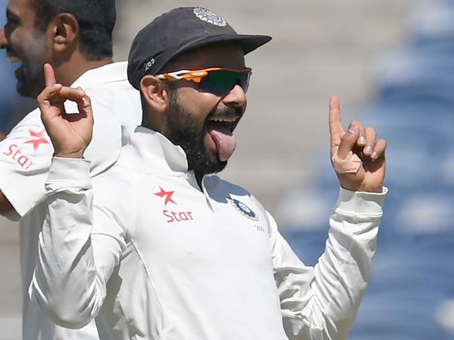 (FILES) This file photo taken on February 23, 2017 shows India's captain Virat Kohli (R) and teammate Ravichandran Ashwin celebrate after the dismissal of Australia's captain Steve Smith during the first day of the first cricket Test match between India and Australia at The Maharashtra Cricket Association Stadium in Pune. India clinched a hard-fought series against Australia 2-1 after winning the fourth and final Test in Dharamsala. ----IMAGE RESTRICTED TO EDITORIAL USE - STRICTLY NO COMMERCIAL USE----- / GETTYOUT----   / AFP PHOTO / INDRANIL MUKHERJEE / ----IMAGE RESTRICTED TO EDITORIAL USE - STRICTLY NO COMMERCIAL USE----- / GETTYOUT