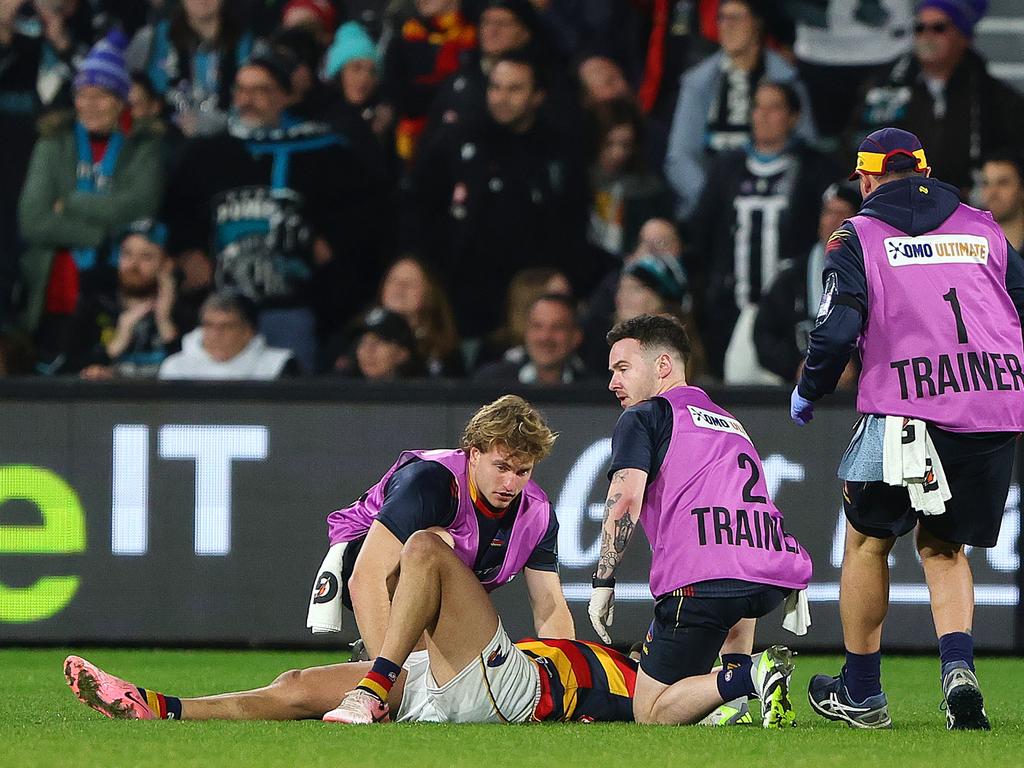 Rankine is seen to by Adelaide trainers. Picture: Sarah Reed/AFL Photos via Getty Images