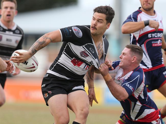 Rugby League Gold Coast grand final between Runaway Bay and Tweed Heads at  Pizzey Park. Tweeds Harrison Hughes flicks one out the back despite the attention of Bays John Mackin. Picture Glenn Hampson
